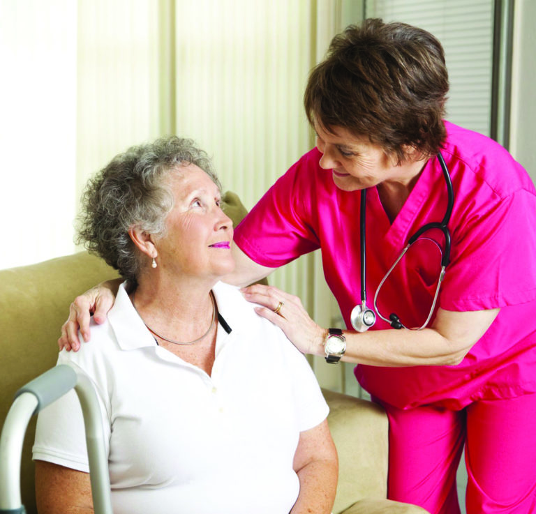 a nurse assisting an elderly